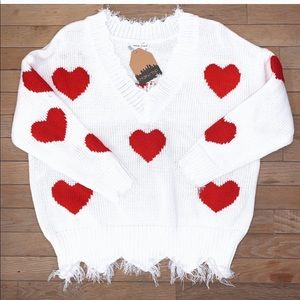 White distressed sweater with red hearts